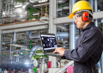 مهندس صناعي يستخدم لوحة بيانات ذكية تشرح ما هي الصيانة التنبؤية لمراقبة أداء المعدات ومنع الأعطال